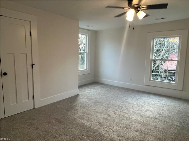 spare room featuring carpet flooring and ceiling fan