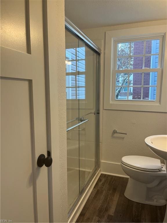 bathroom with sink, toilet, wood-type flooring, and walk in shower