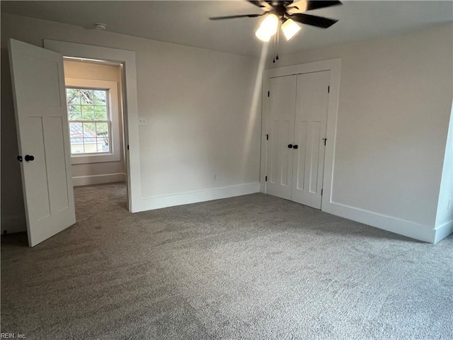 empty room featuring carpet flooring and ceiling fan