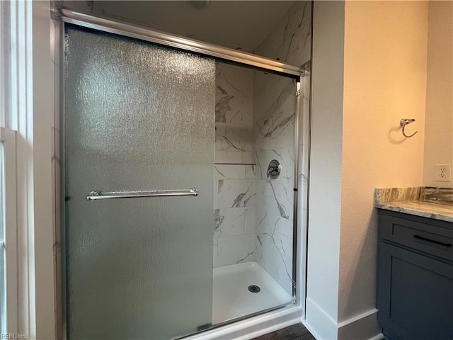 bathroom featuring vanity and an enclosed shower