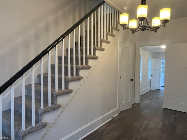 stairway featuring a chandelier and hardwood / wood-style flooring