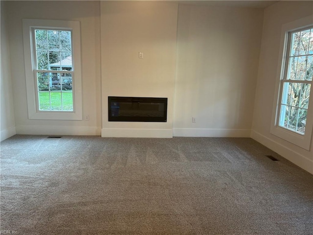 unfurnished living room featuring carpet flooring