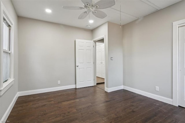 unfurnished bedroom featuring ceiling fan and dark wood-type flooring