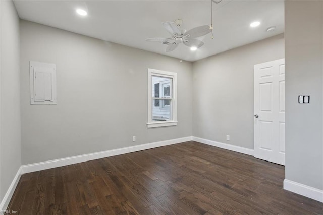 empty room with ceiling fan, dark hardwood / wood-style floors, and electric panel