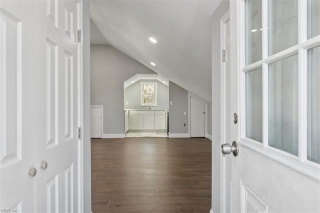 additional living space featuring lofted ceiling and dark hardwood / wood-style flooring