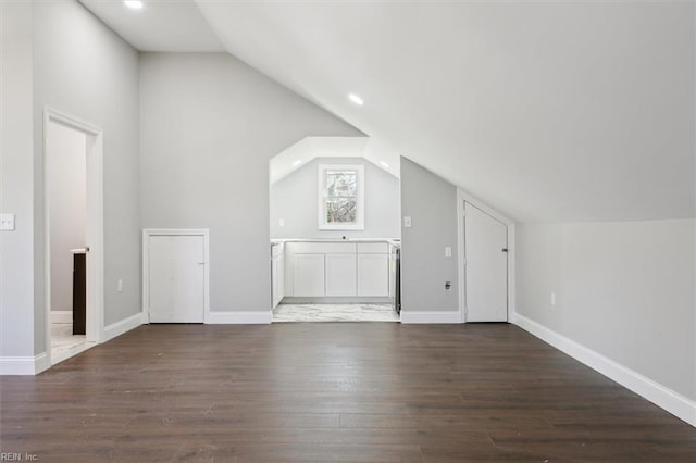 additional living space with dark hardwood / wood-style flooring and lofted ceiling