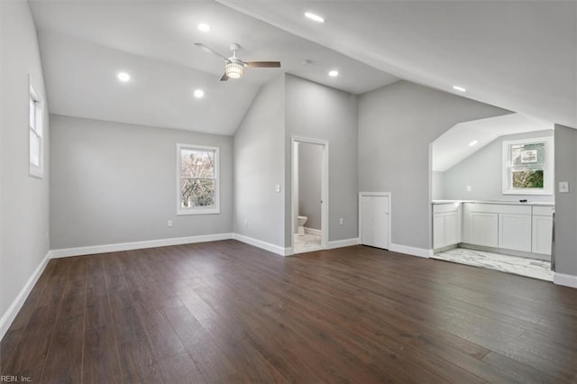 bonus room featuring dark wood-type flooring, lofted ceiling, and ceiling fan