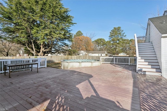 deck with a fenced in pool