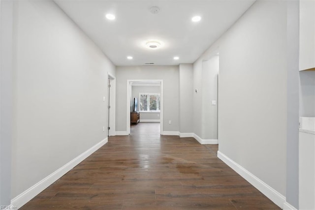 corridor with dark hardwood / wood-style floors