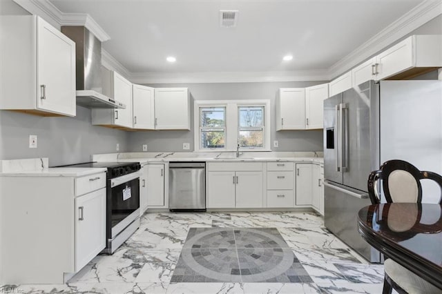 kitchen with sink, white cabinets, appliances with stainless steel finishes, and wall chimney exhaust hood