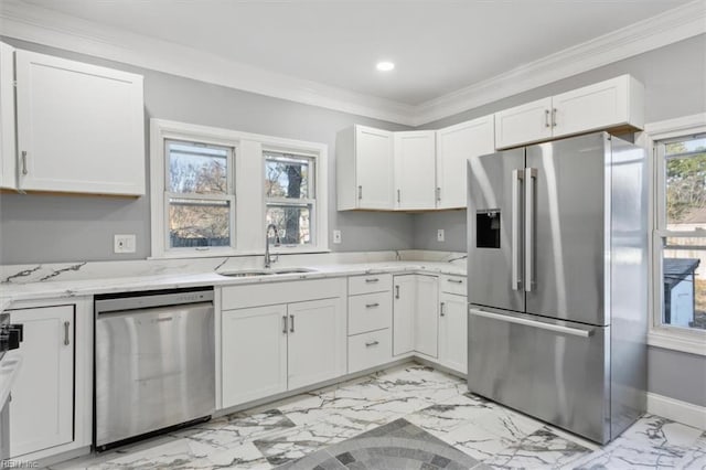 kitchen with stainless steel appliances, crown molding, white cabinets, and sink