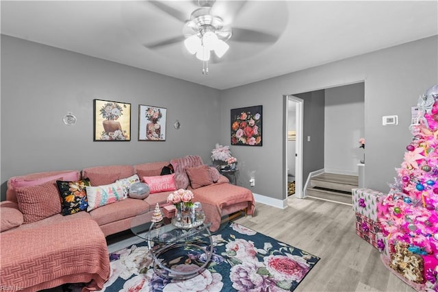 living room featuring light hardwood / wood-style floors and ceiling fan