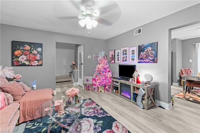 living room with ceiling fan and light hardwood / wood-style floors