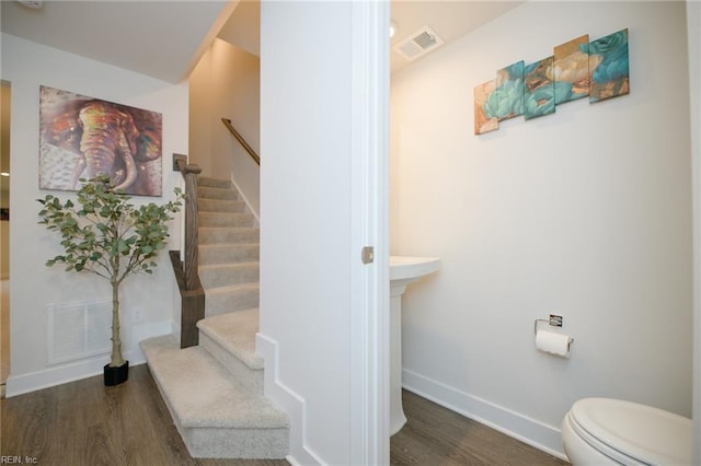 staircase with hardwood / wood-style floors