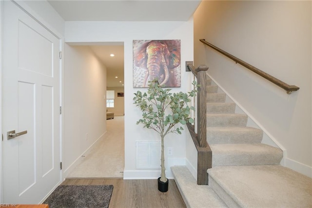 staircase featuring wood-type flooring