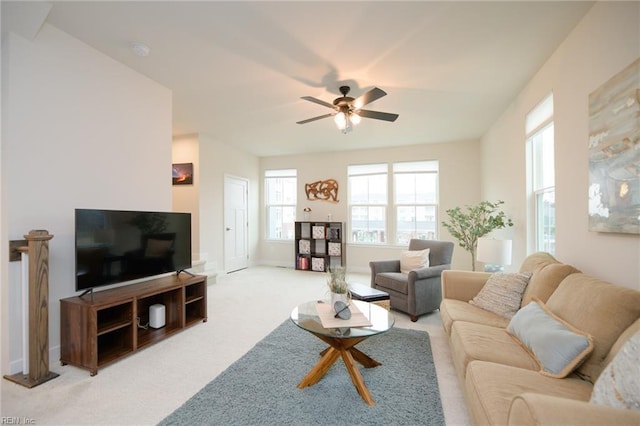 carpeted living room featuring ceiling fan