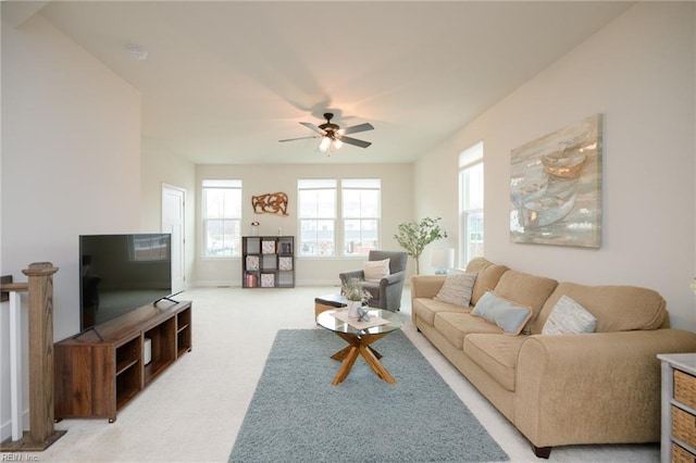 carpeted living room with ceiling fan