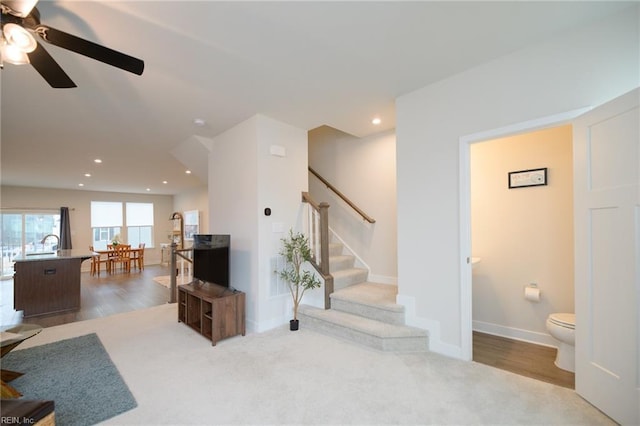 living room featuring ceiling fan and light hardwood / wood-style flooring