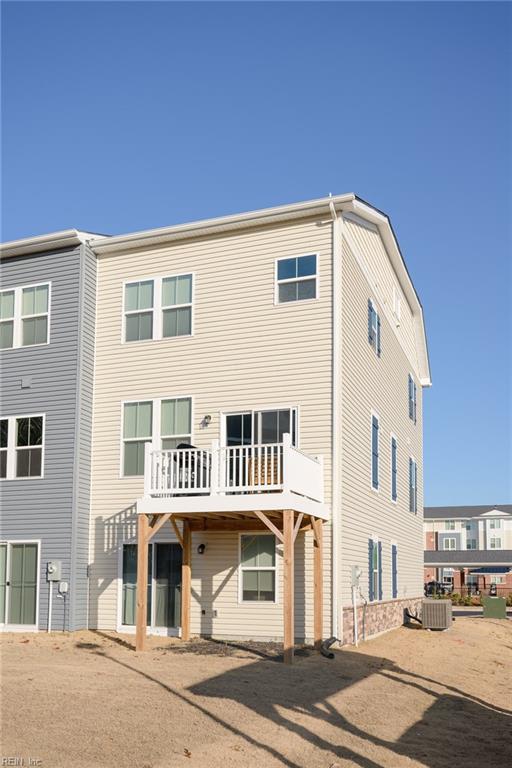 rear view of property featuring cooling unit and a deck