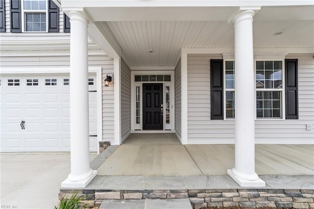 entrance to property with a porch and a garage