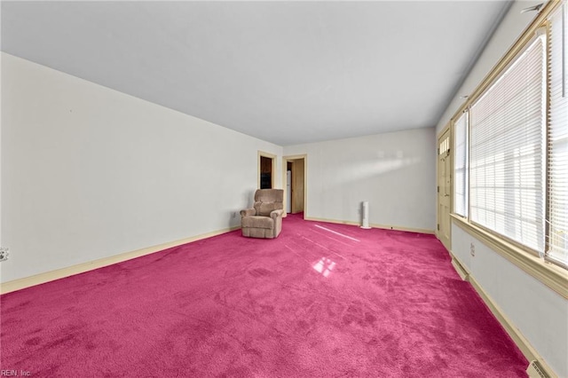 carpeted empty room with baseboard heating