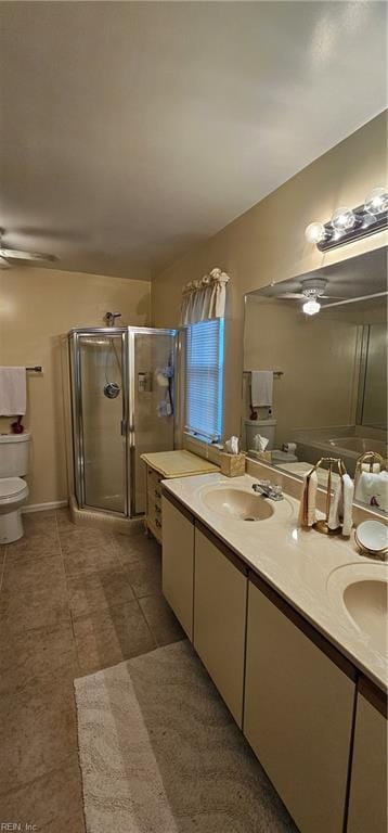 bathroom featuring vanity, toilet, walk in shower, and ceiling fan