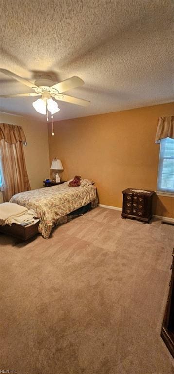 unfurnished bedroom featuring carpet flooring, ceiling fan, and a textured ceiling