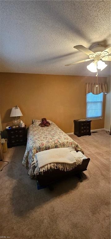 carpeted bedroom featuring ceiling fan and a textured ceiling