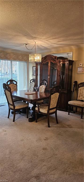 dining room with carpet flooring, a textured ceiling, and an inviting chandelier