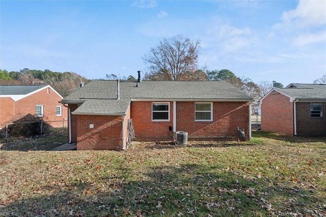 back of house featuring central AC unit and a yard