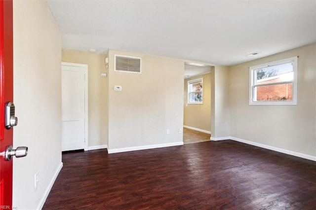 empty room with dark hardwood / wood-style floors