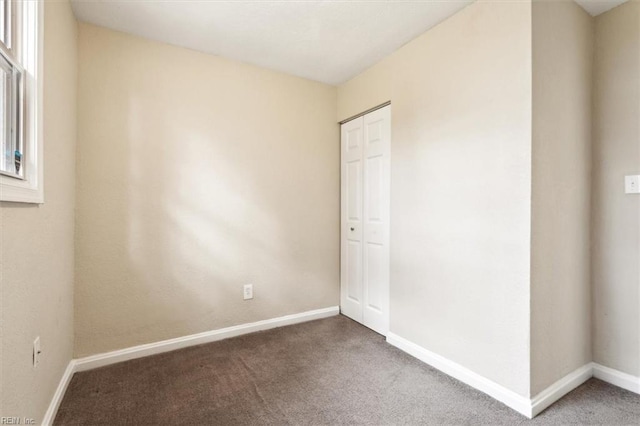 unfurnished bedroom with carpet floors and a closet