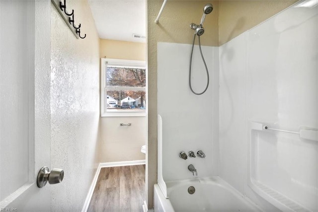 bathroom with bathtub / shower combination and wood-type flooring