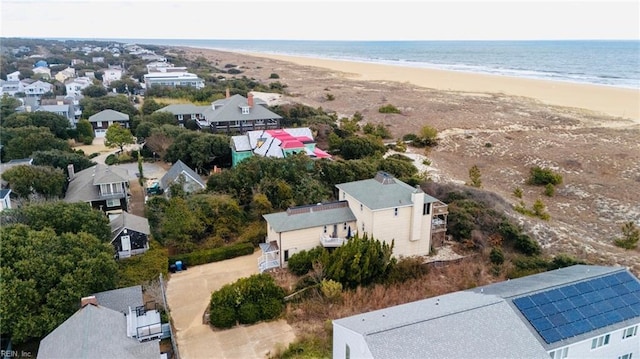 bird's eye view with a water view and a beach view