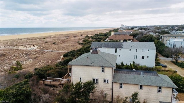 drone / aerial view featuring a water view and a beach view