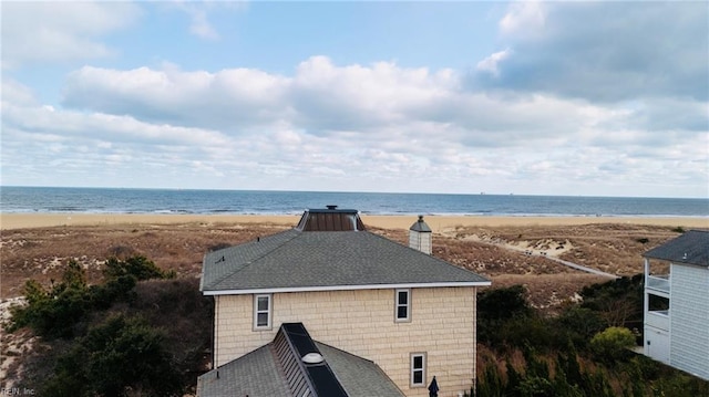 drone / aerial view with a water view and a view of the beach