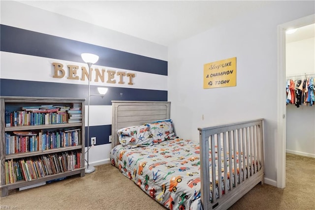 carpeted bedroom featuring a spacious closet and a closet