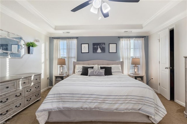 bedroom featuring a raised ceiling, multiple windows, ceiling fan, and carpet floors