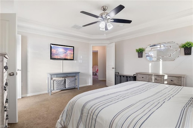 bedroom featuring carpet, a tray ceiling, ceiling fan, and crown molding