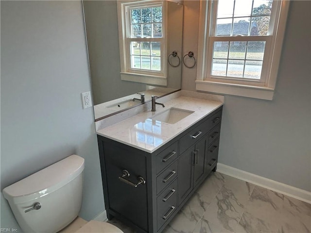 bathroom featuring vanity and toilet