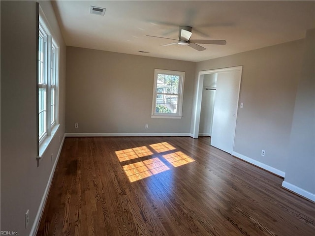 unfurnished bedroom featuring ceiling fan and dark hardwood / wood-style floors