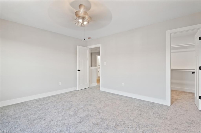 unfurnished room with ceiling fan and light carpet