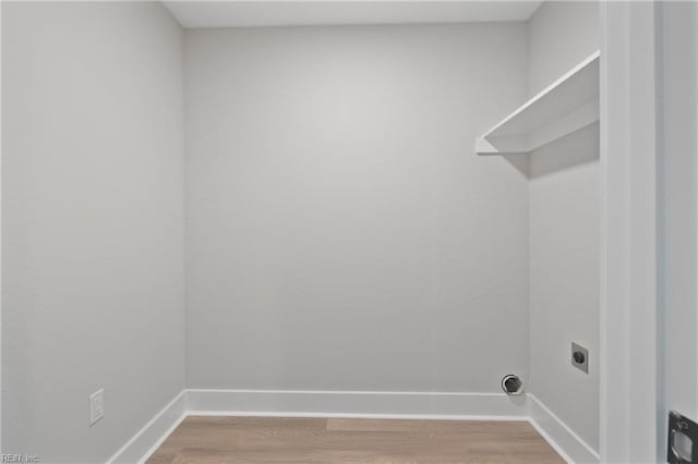 laundry room with hardwood / wood-style flooring and hookup for an electric dryer