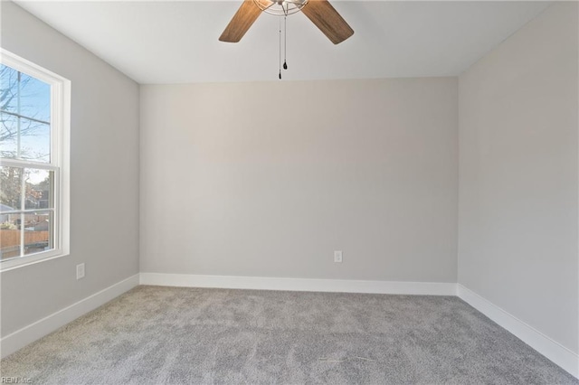 spare room with ceiling fan and light colored carpet