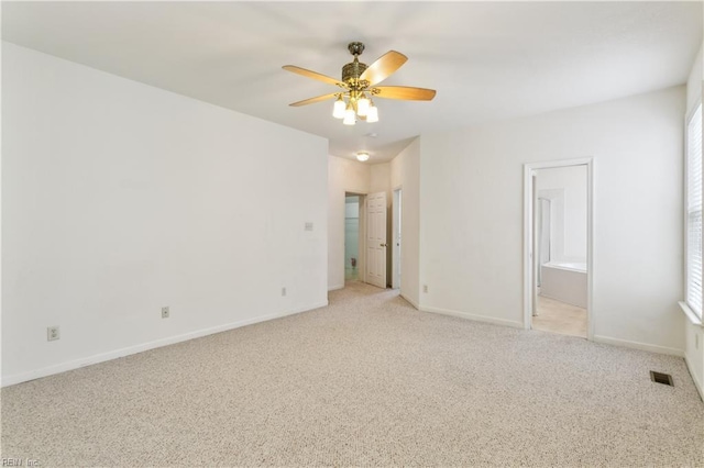 unfurnished bedroom featuring connected bathroom, light colored carpet, and ceiling fan