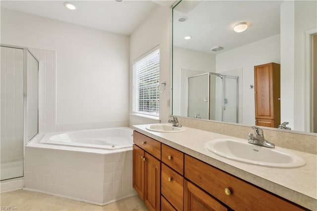 bathroom featuring shower with separate bathtub, vanity, and tile patterned floors