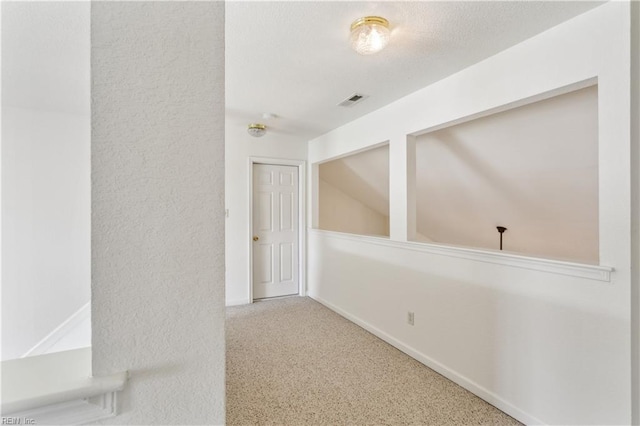 hall with carpet floors and lofted ceiling