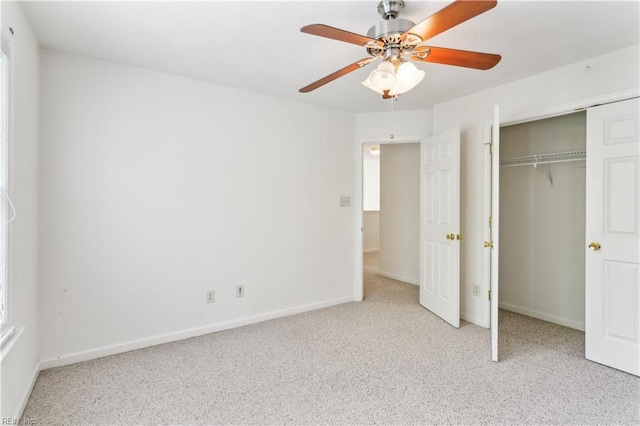 unfurnished bedroom with ceiling fan, a closet, and light colored carpet