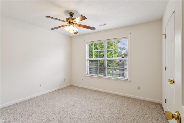 carpeted spare room with ceiling fan