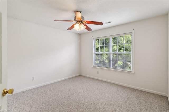 carpeted spare room with ceiling fan